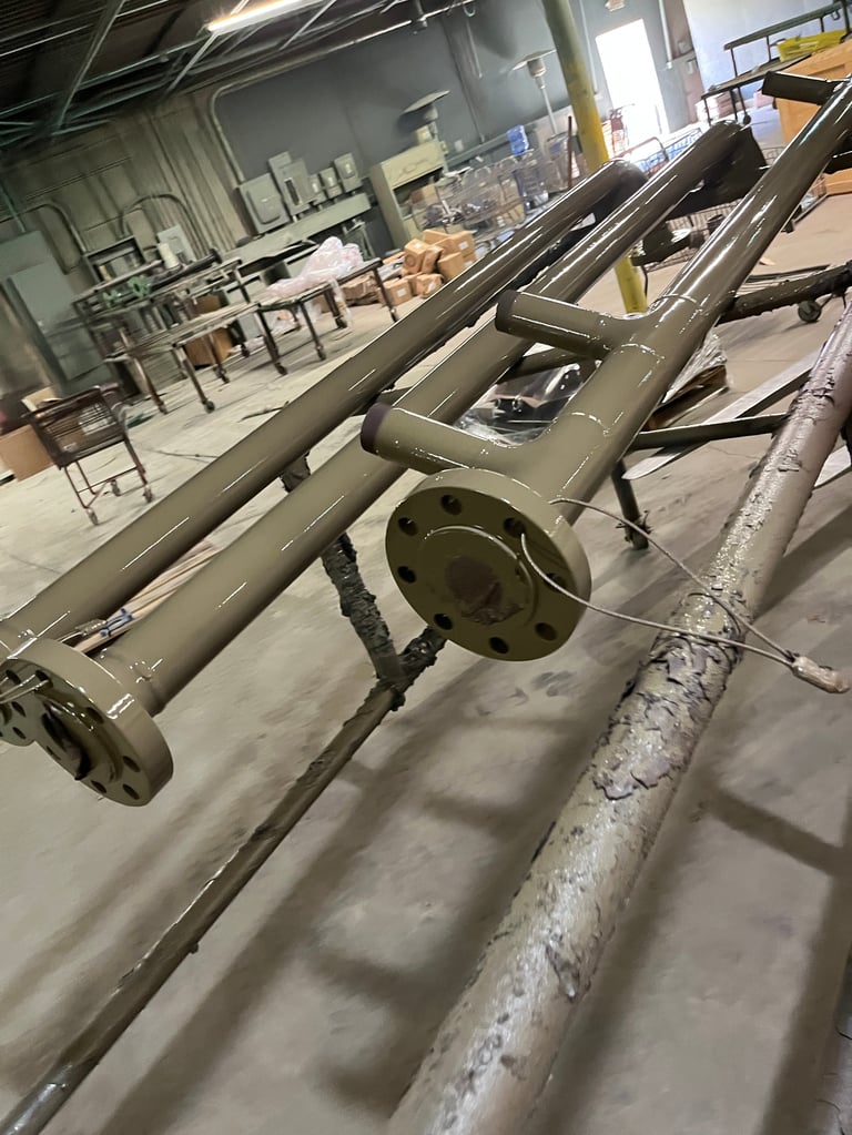 Industrial machinery with gray metal pipe and coupling assembly on warehouse floor